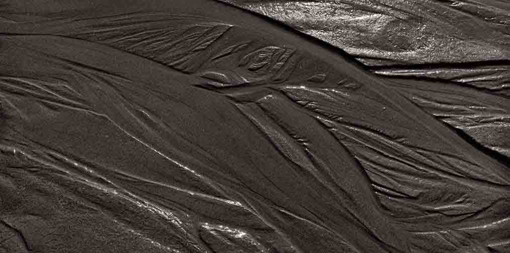 Photographie numérique du passage de l'eau dans le sable à marée basse